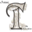 Decorative floral letter T machine embroidery design with ornamental accents